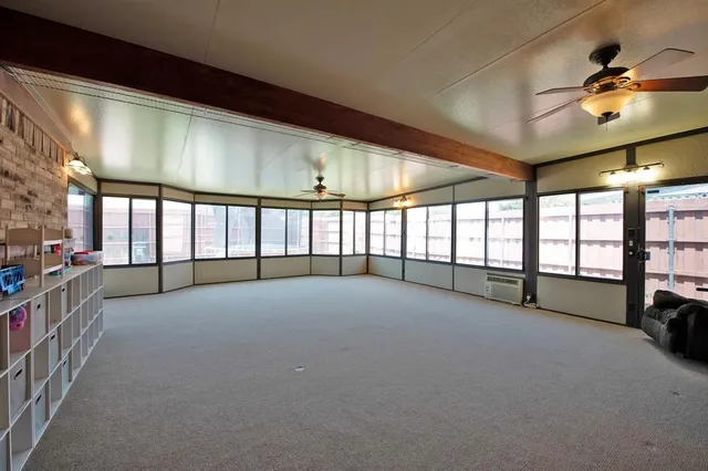 a view of an empty room with windows
