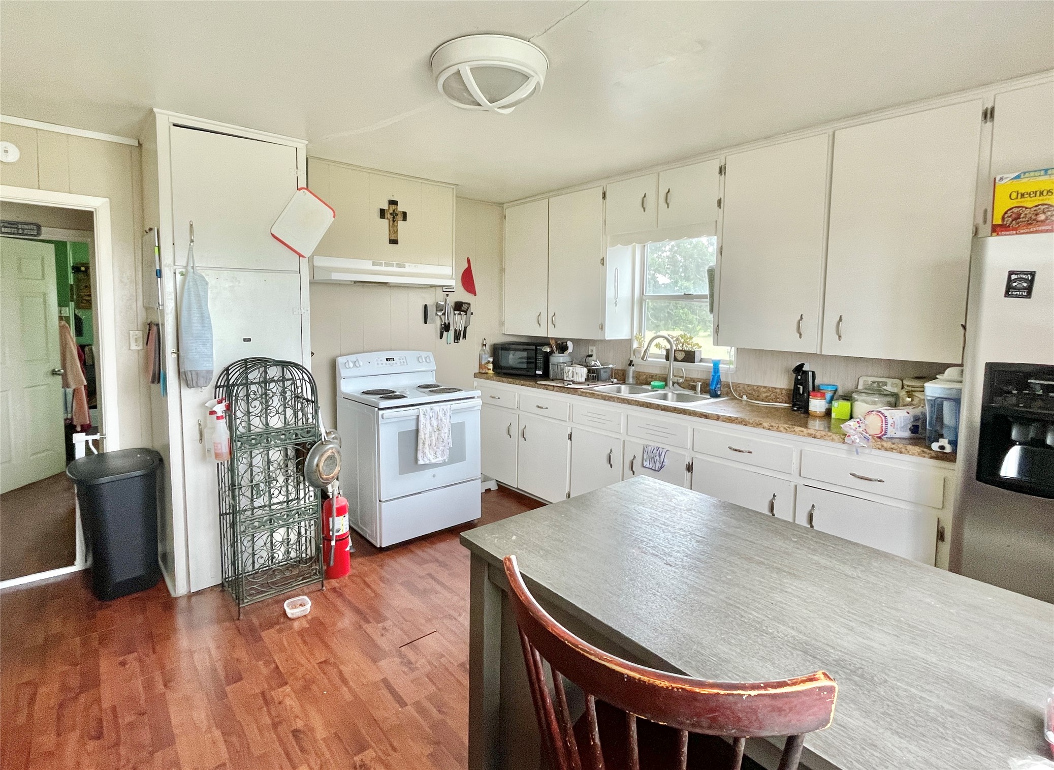 136 Fm 2239 Road Paige, TX 78659 - Photo 7 of 29 a kitchen that has a lot of cabinets in it and wooden floors