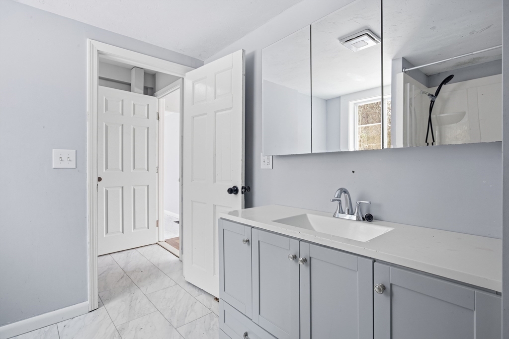 2230 Cranberry Highway, Unit A Wareham, MA 02576 - Photo 12 of 25 a bathroom with a sink and mirror