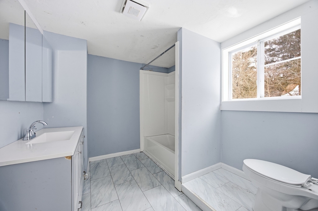 2230 Cranberry Highway, Unit A Wareham, MA 02576 - Photo 13 of 25 a bathroom with a sink toilet and vanity