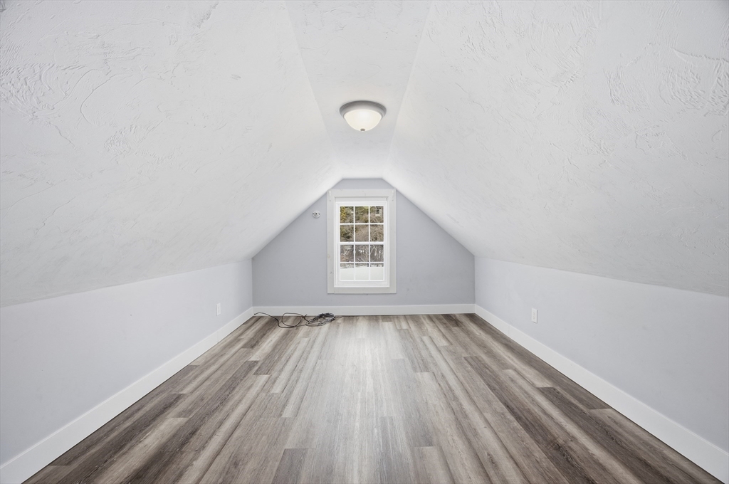 2230 Cranberry Highway, Unit A Wareham, MA 02576 - Photo 17 of 25 an empty room with wooden floor and windows