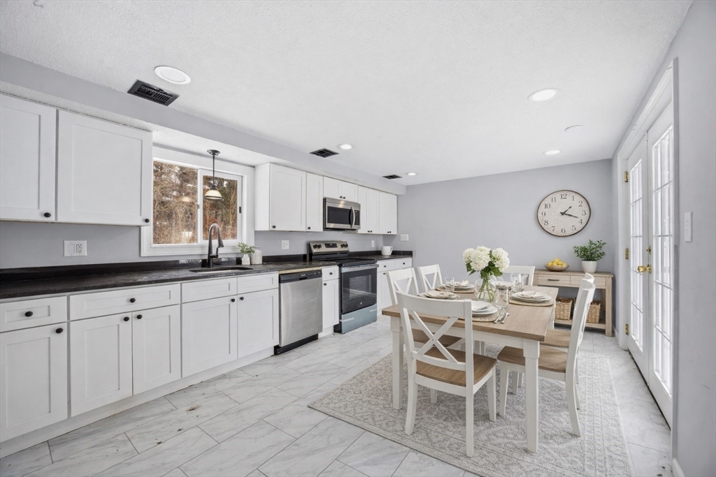 2230 Cranberry Highway, Unit A Wareham, MA 02576 - Photo 3 of 25 a kitchen with a sink and chairs