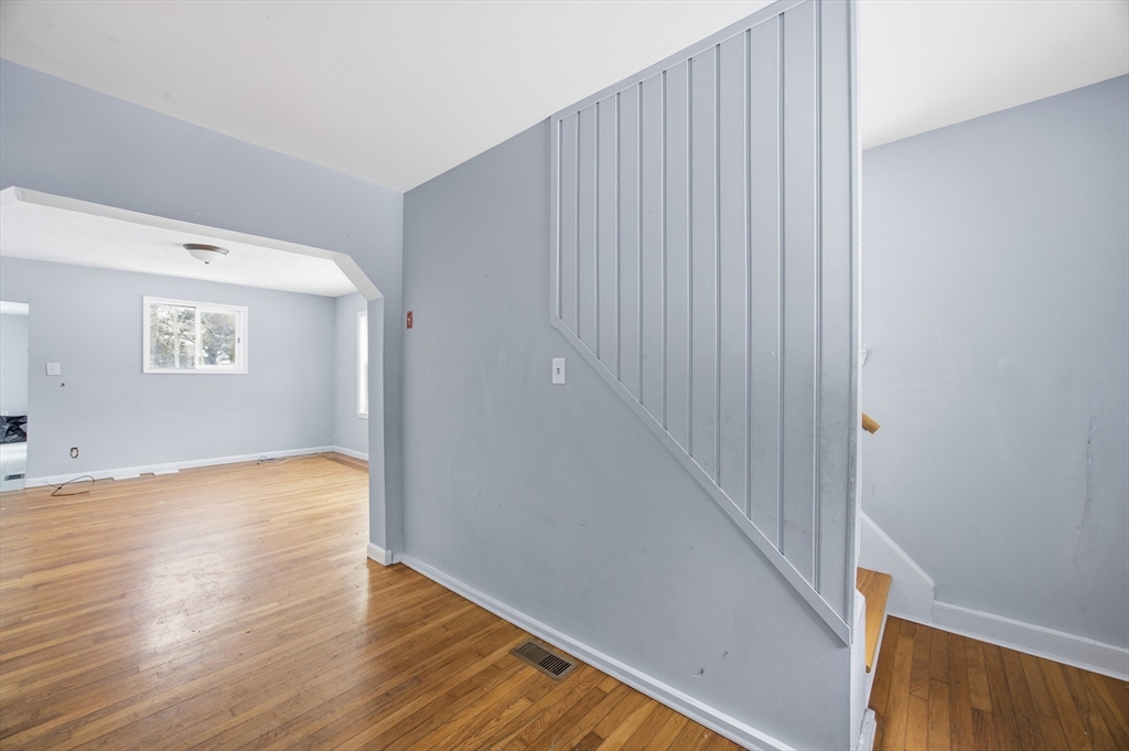 2230 Cranberry Highway, Unit A Wareham, MA 02576 - Photo 6 of 25 a view of an empty room with wooden floor and a window