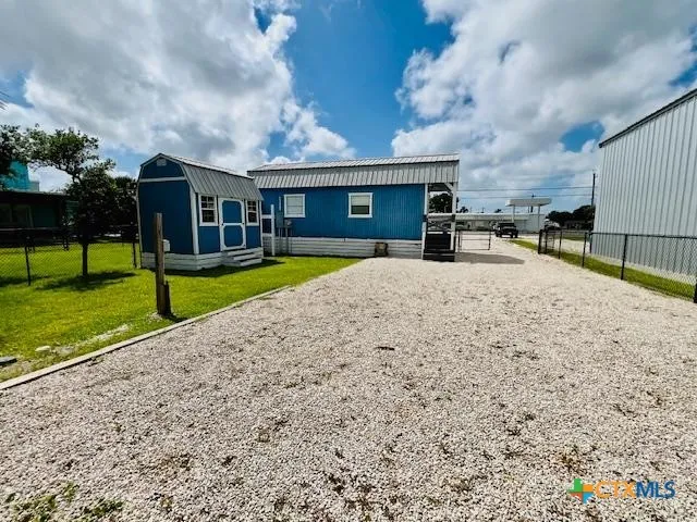 a view of a house with a yard and sitting area