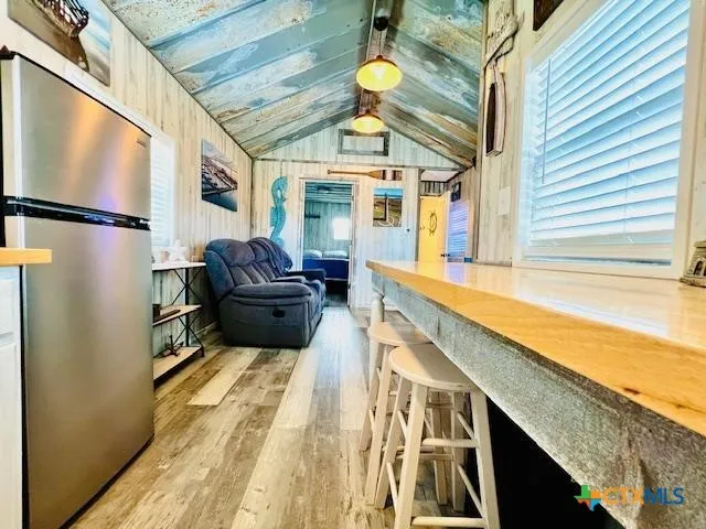 a bathroom with a tub and a large window