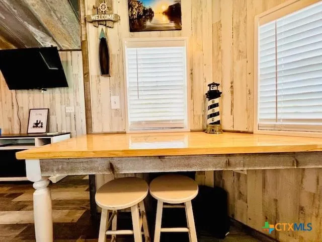a kitchen with a table chairs and a sink