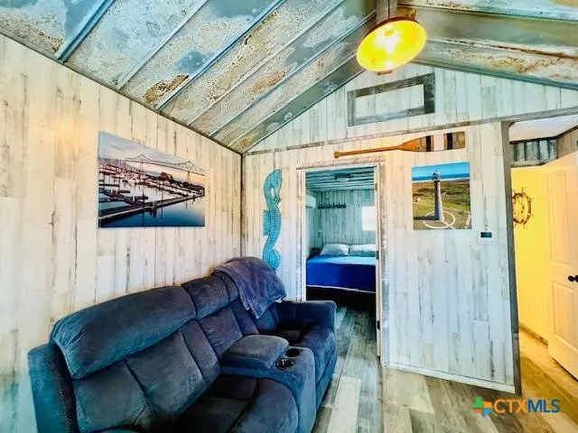 a living room with furniture and a painting on the wall