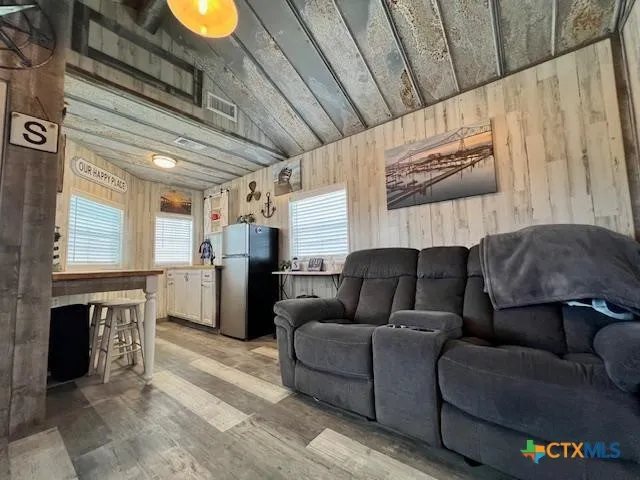a living room with furniture and a kitchen