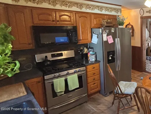 a kitchen with stainless steel appliances granite countertop a stove and a microwave