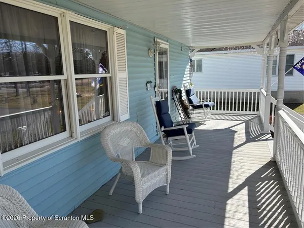 a view of a deck with table and chairs with wooden floor