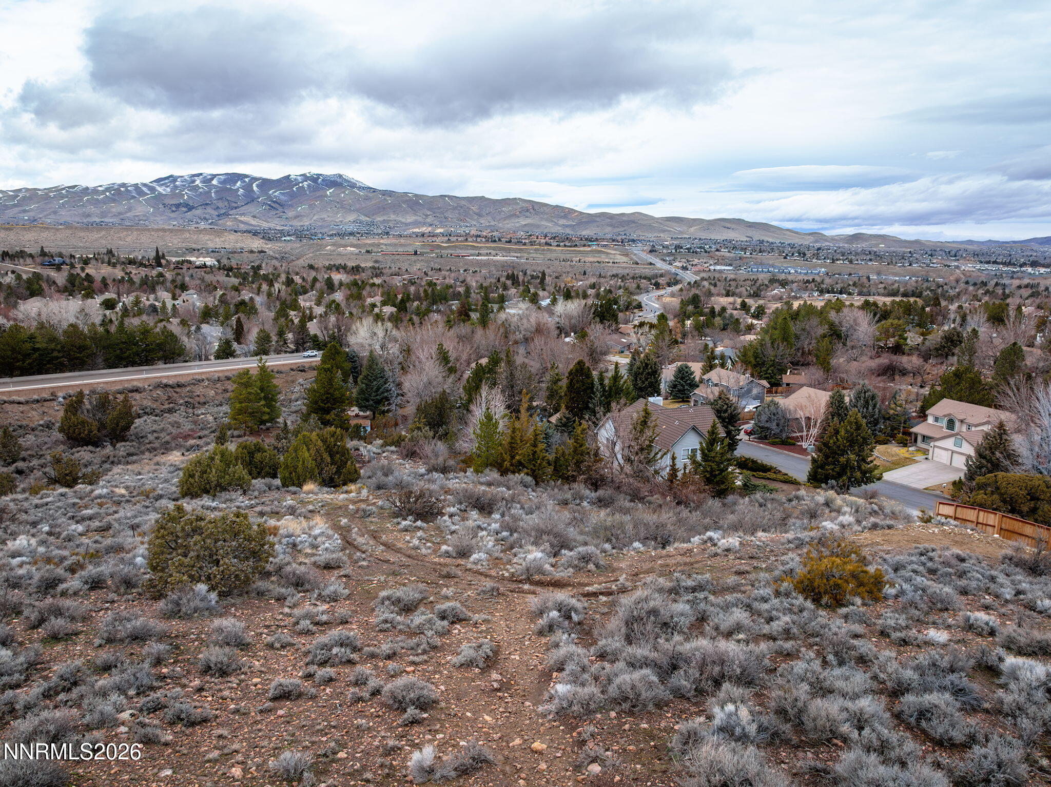 3300 Thornhill Drive Reno, NV 89509 - Photo 6 of 8 a view of a dry field with mountains in the background