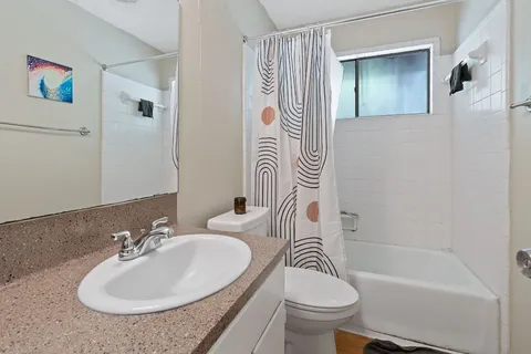 a bathroom with a sink a toilet and a bathtub