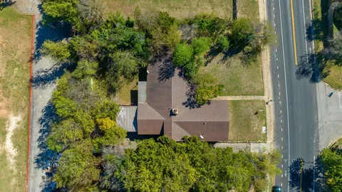 an aerial view of a house with swimming pool and garden