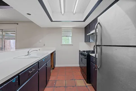 a kitchen with a sink appliances and cabinets