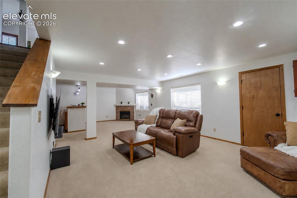 789 Capeglen Road Colorado Springs, CO 80906 - Photo 29 of 46 Large Basement with storage and second fireplace w/ wet bar w/ fridge