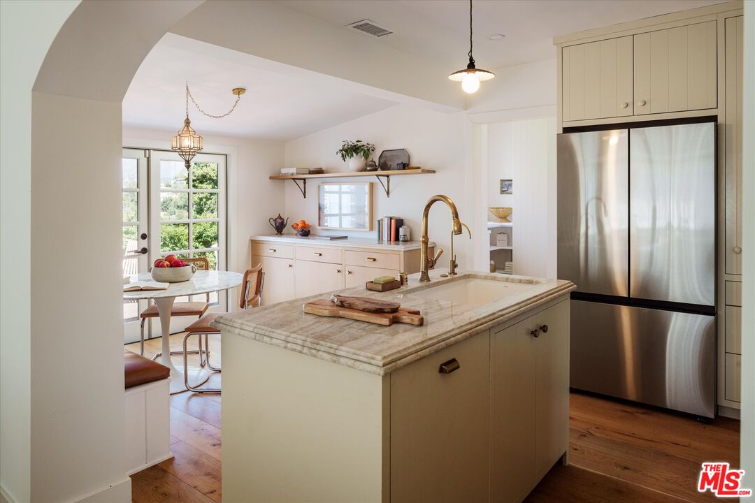 1410 Stanford Drive Glendale, CA 91205 - Photo 12 of 31 a kitchen with stainless steel appliances granite countertop a refrigerator a sink dishwasher a stove and a dining table with wooden floor