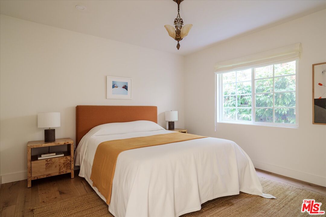 1410 Stanford Drive Glendale, CA 91205 - Photo 21 of 31 a bedroom with a bed and wooden floor