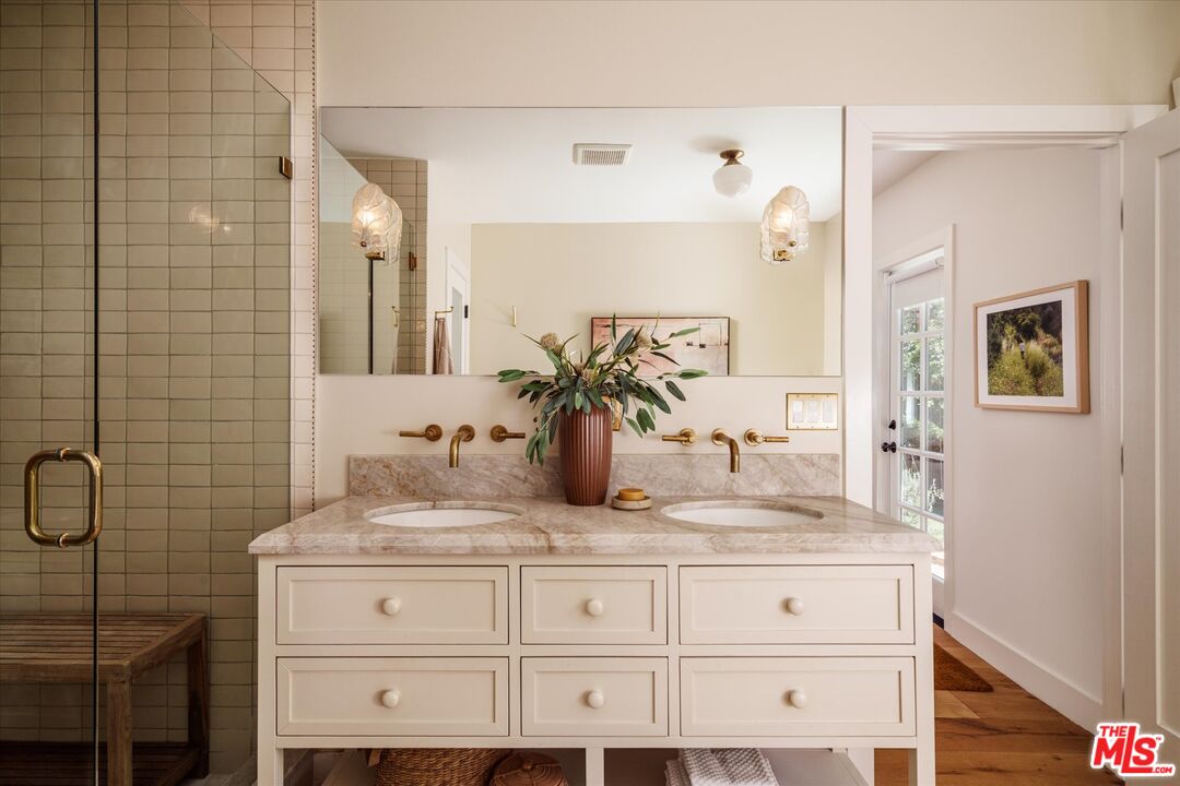 1410 Stanford Drive Glendale, CA 91205 - Photo 26 of 31 a bathroom with a granite countertop sink a vanity and a mirror