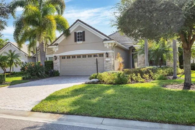 a front view of a house with a yard and garage