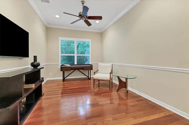 a bed sitting in a bedroom next to a window with a bookshelf