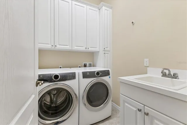a kitchen with a stove a sink and a wooden floor