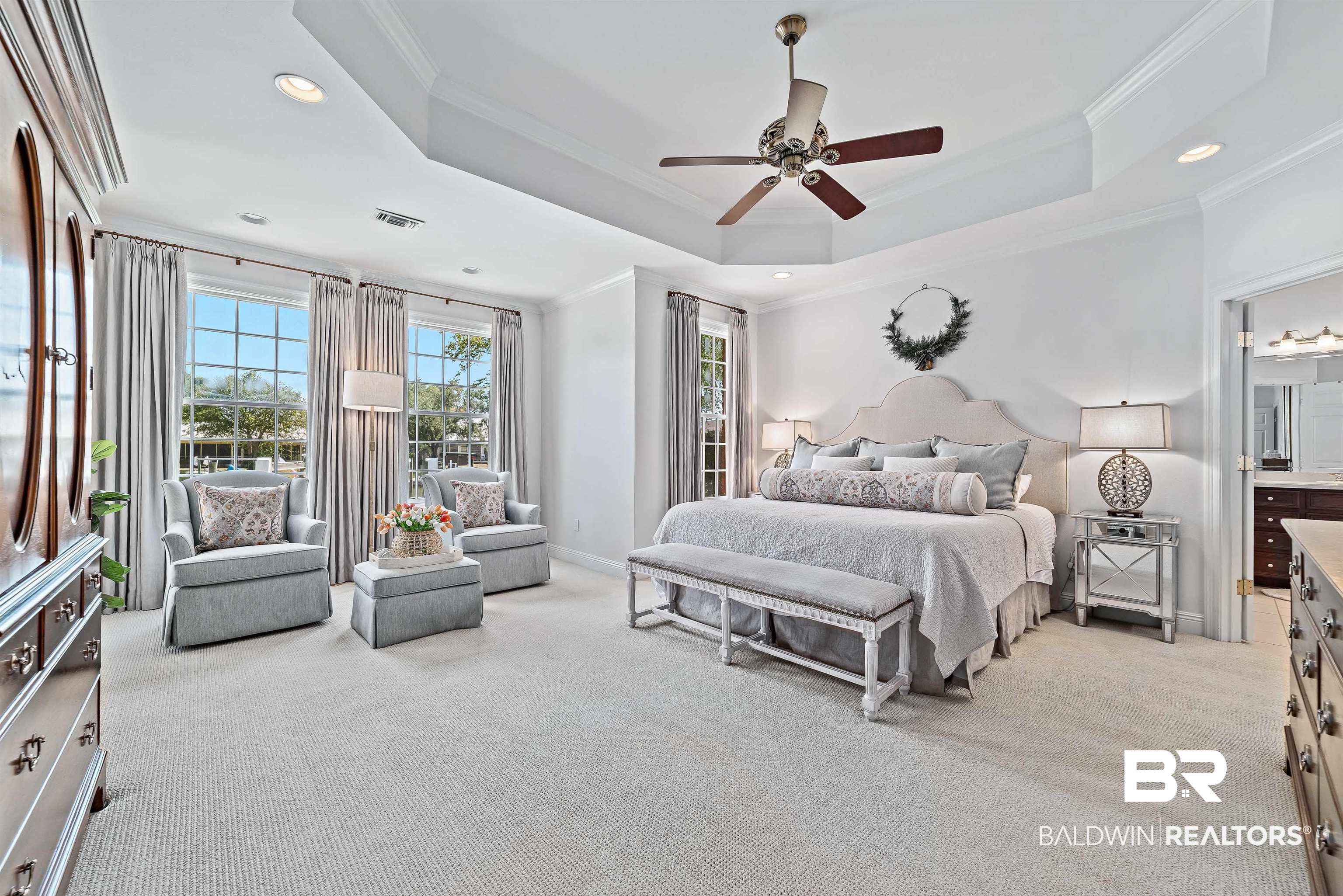 6630 East Quarry Drive Elberta, AL 36530 - Photo 20 of 63 Bedroom featuring a tray ceiling, crown molding, recessed lighting, light carpet, and a ceiling fan