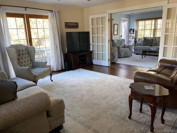 a living room with furniture and a book shelf