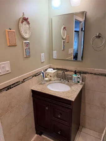 a bathroom with a tub sink and mirror