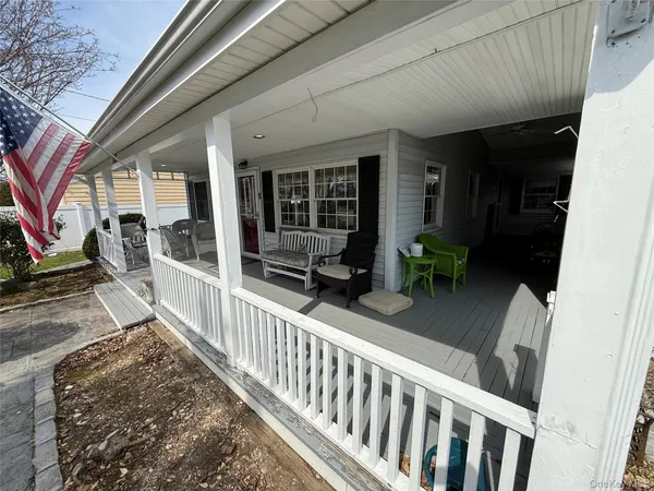 a view of a house with porch and furniture