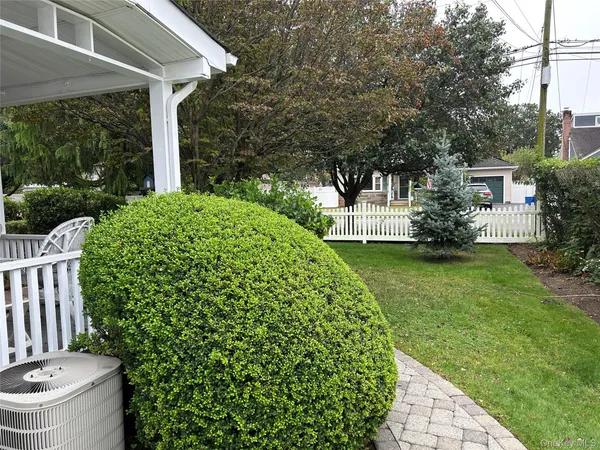 a kitchen with stainless steel appliances granite countertop a refrigerator a sink dishwasher a stove a dining table and chairs with wooden floor