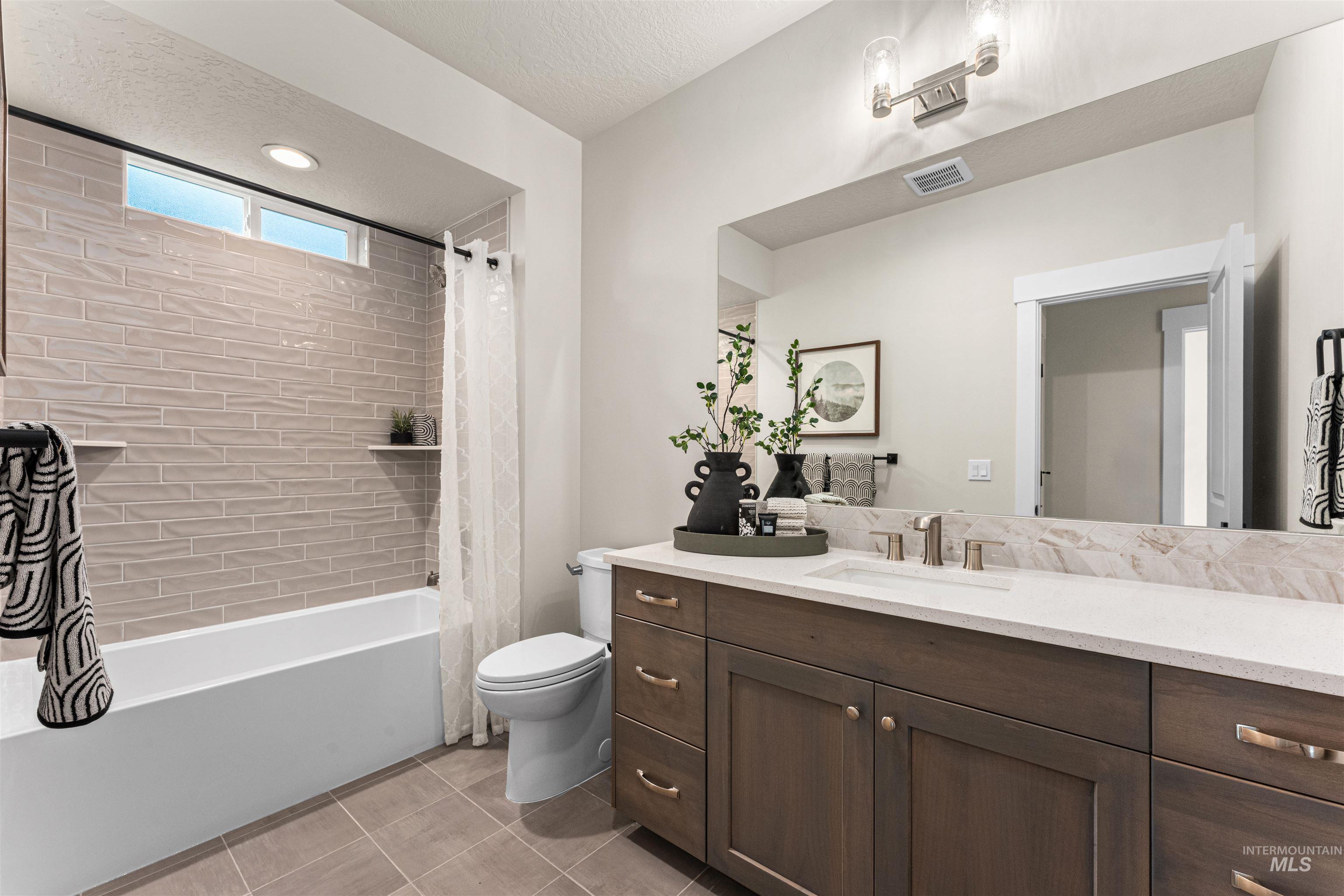 8082 Tandy Cv Street Middleton, ID 83644 - Photo 25 of 37 Full bath with shower / tub combo, vanity, light tile patterned flooring, recessed lighting, and a textured ceiling