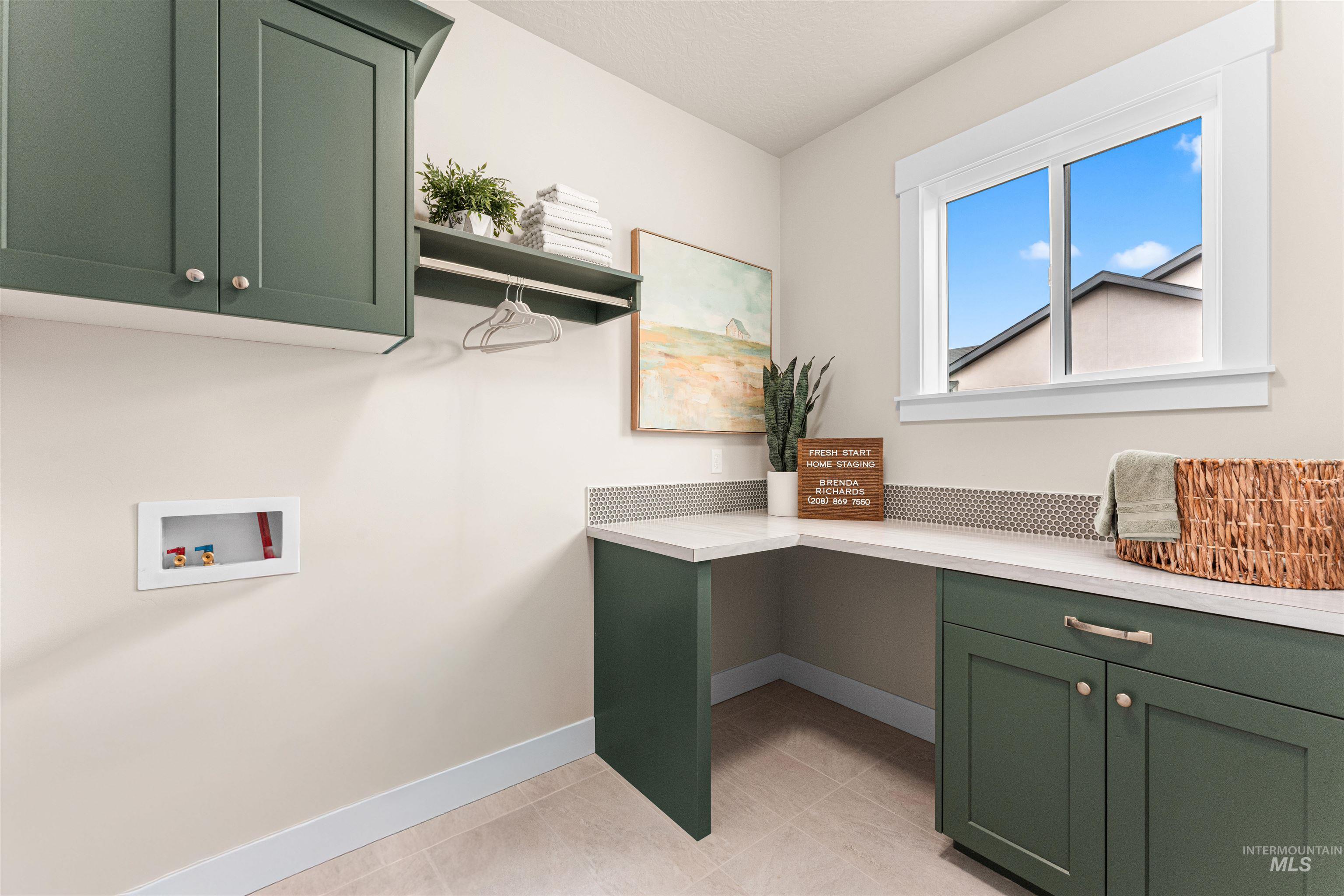 8082 Tandy Cv Street Middleton, ID 83644 - Photo 27 of 37 Laundry area featuring cabinet space, hookup for a washing machine, and light tile patterned floors