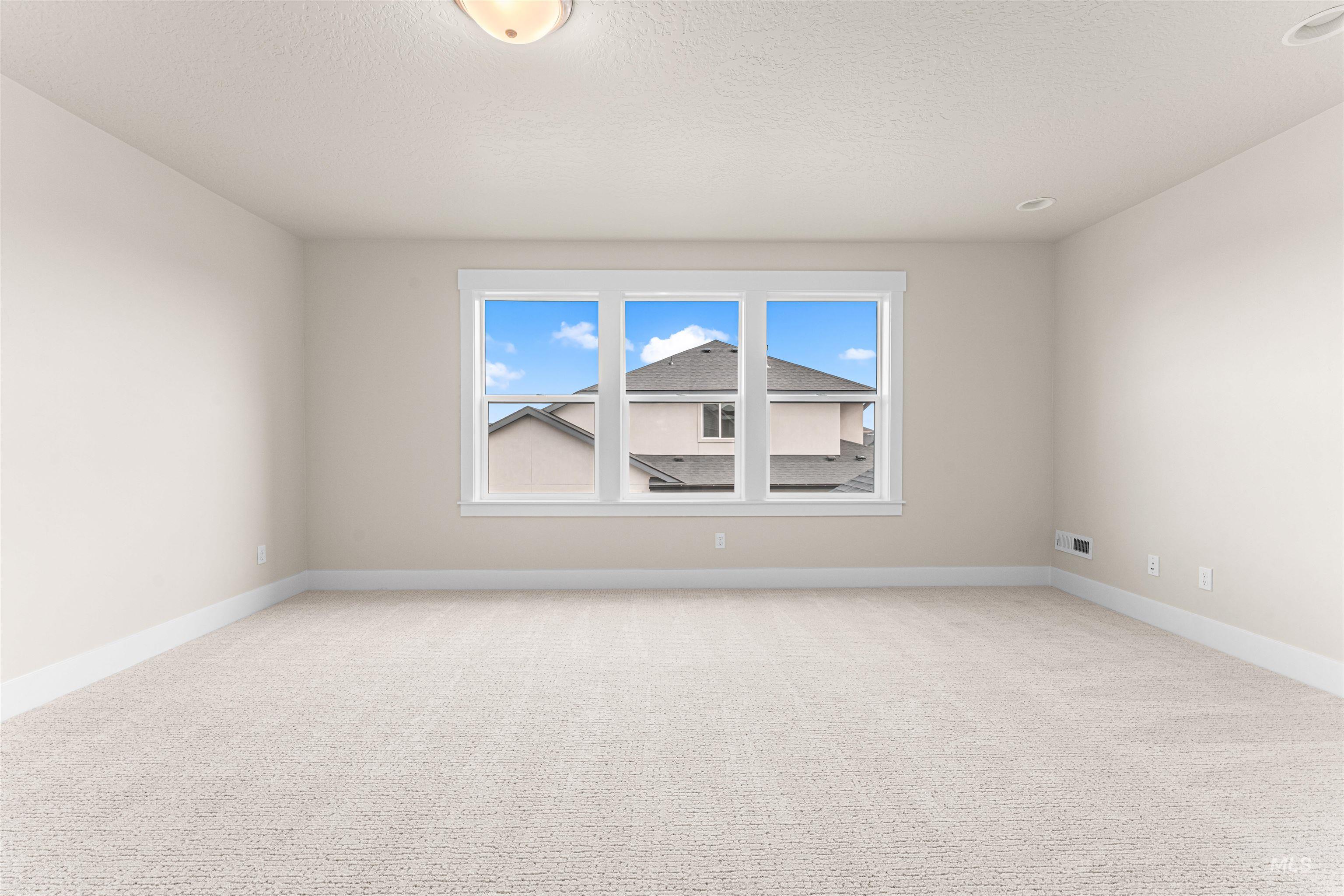 8082 Tandy Cv Street Middleton, ID 83644 - Photo 31 of 37 Empty room with light carpet and a textured ceiling