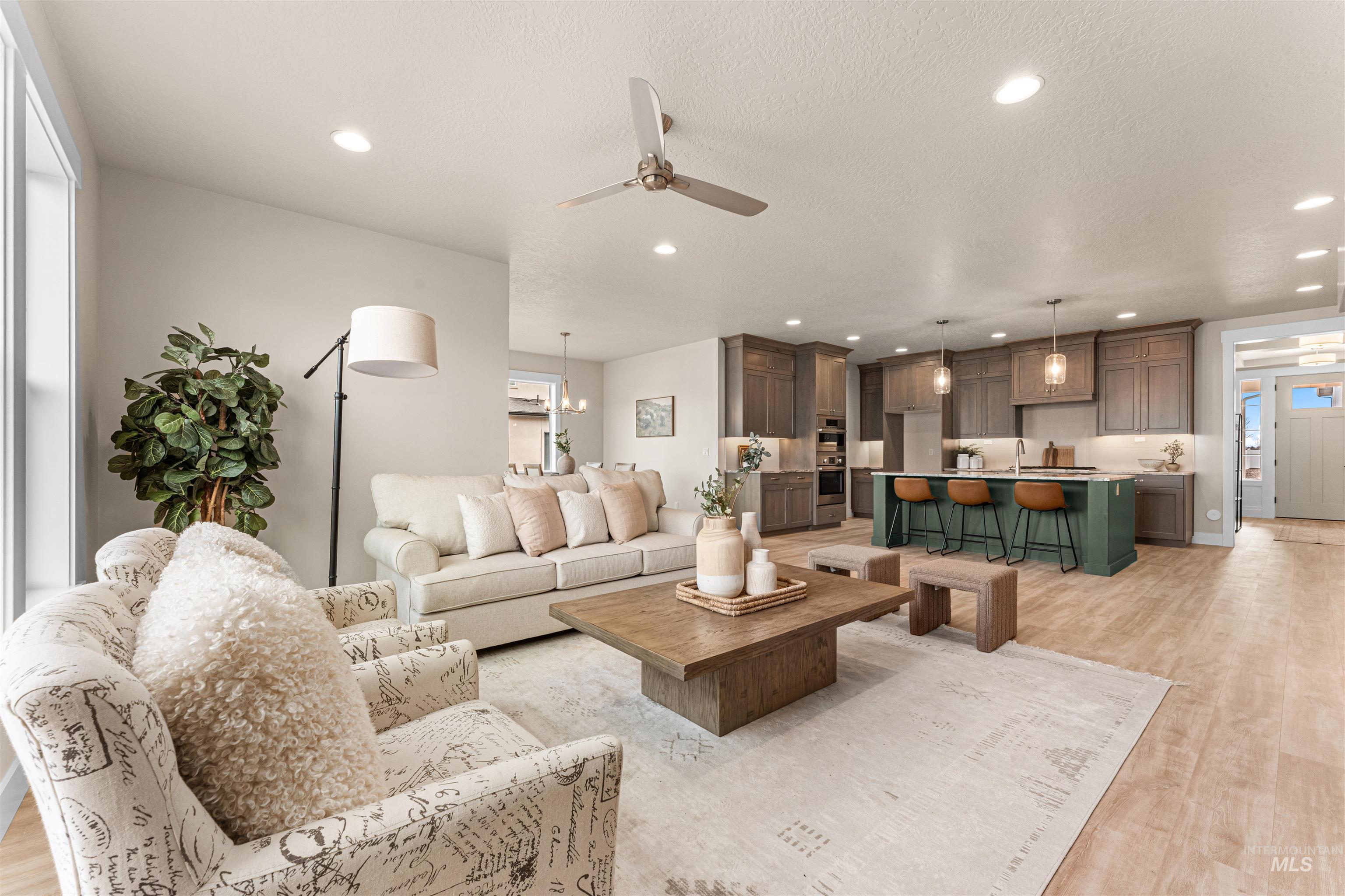 8082 Tandy Cv Street Middleton, ID 83644 - Photo 6 of 37 Living room with light wood-style floors, ceiling fan, and hanging lights