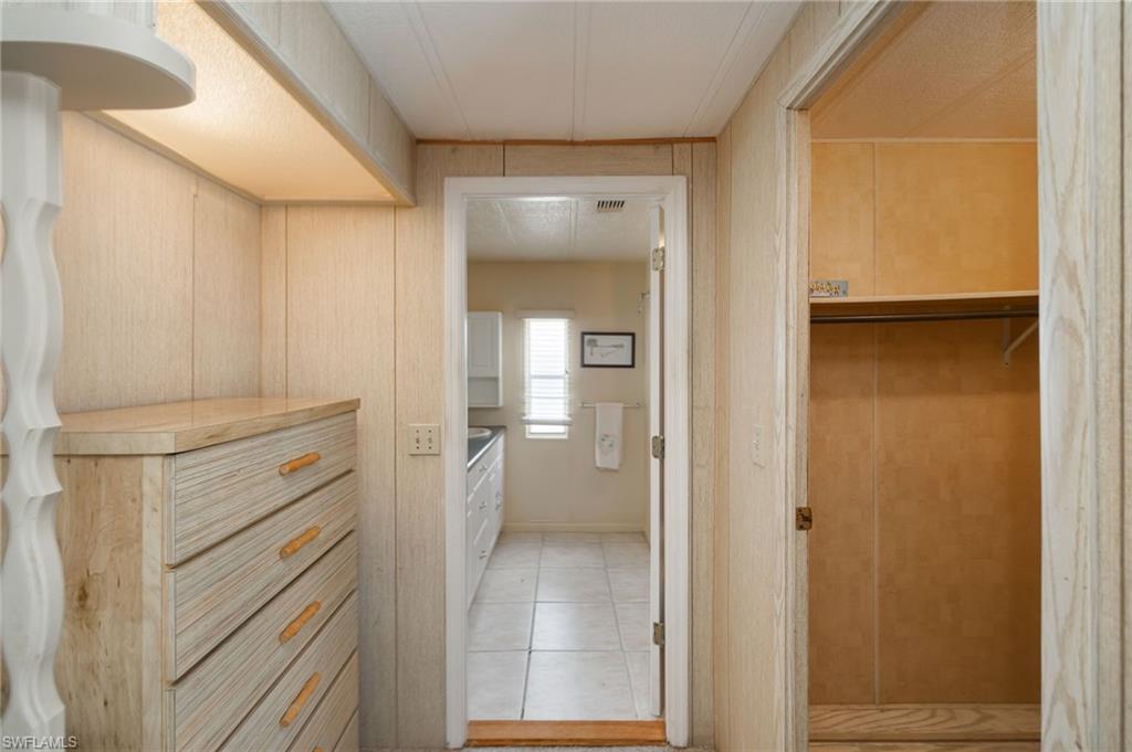 21 San Lu Rue Avenue, Unit 21 Naples, FL 34104 - Photo 14 of 33 a view of walk in closet