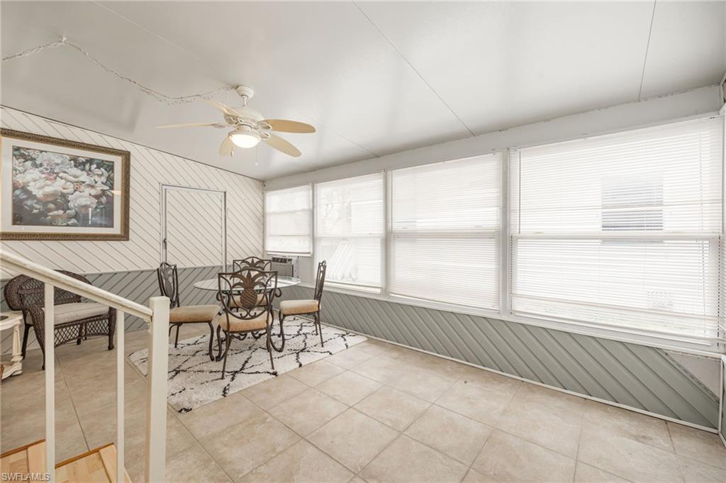 21 San Lu Rue Avenue, Unit 21 Naples, FL 34104 - Photo 23 of 33 a dining room with furniture and window