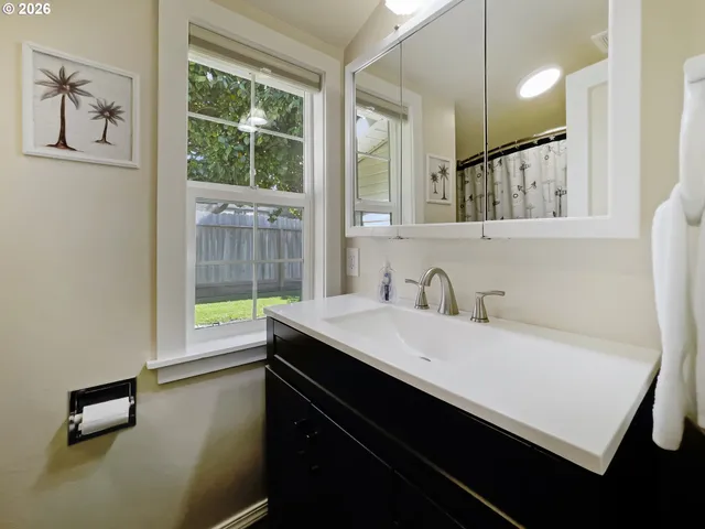 a bathroom with a sink toilet vanity and shower