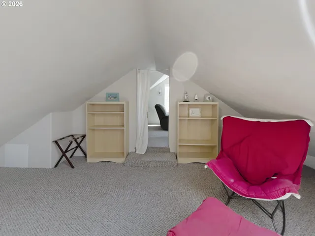 a living room with furniture a flat screen tv and a window