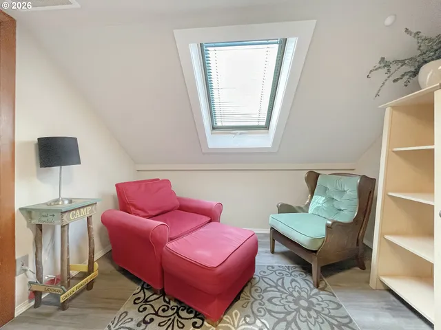 a bedroom with two beds and painting on the wall