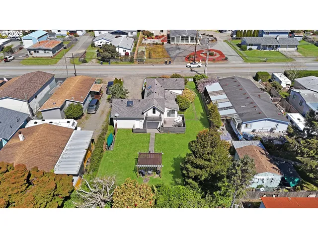 a dining room with furniture and a floor to ceiling window