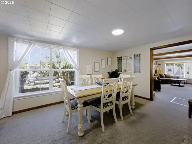 a view of a chairs and table in patio with a yard