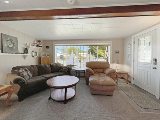 a living room with furniture window and a flat screen tv