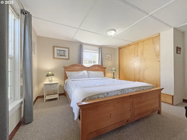 a spacious bedroom with a bed and a window