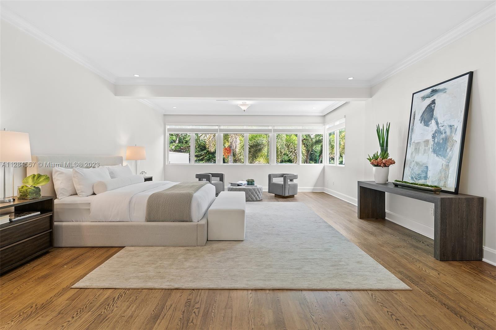 4845 Davis Road Miami, FL 33143 - Photo 17 of 34 a large bedroom with a large bed and a couch