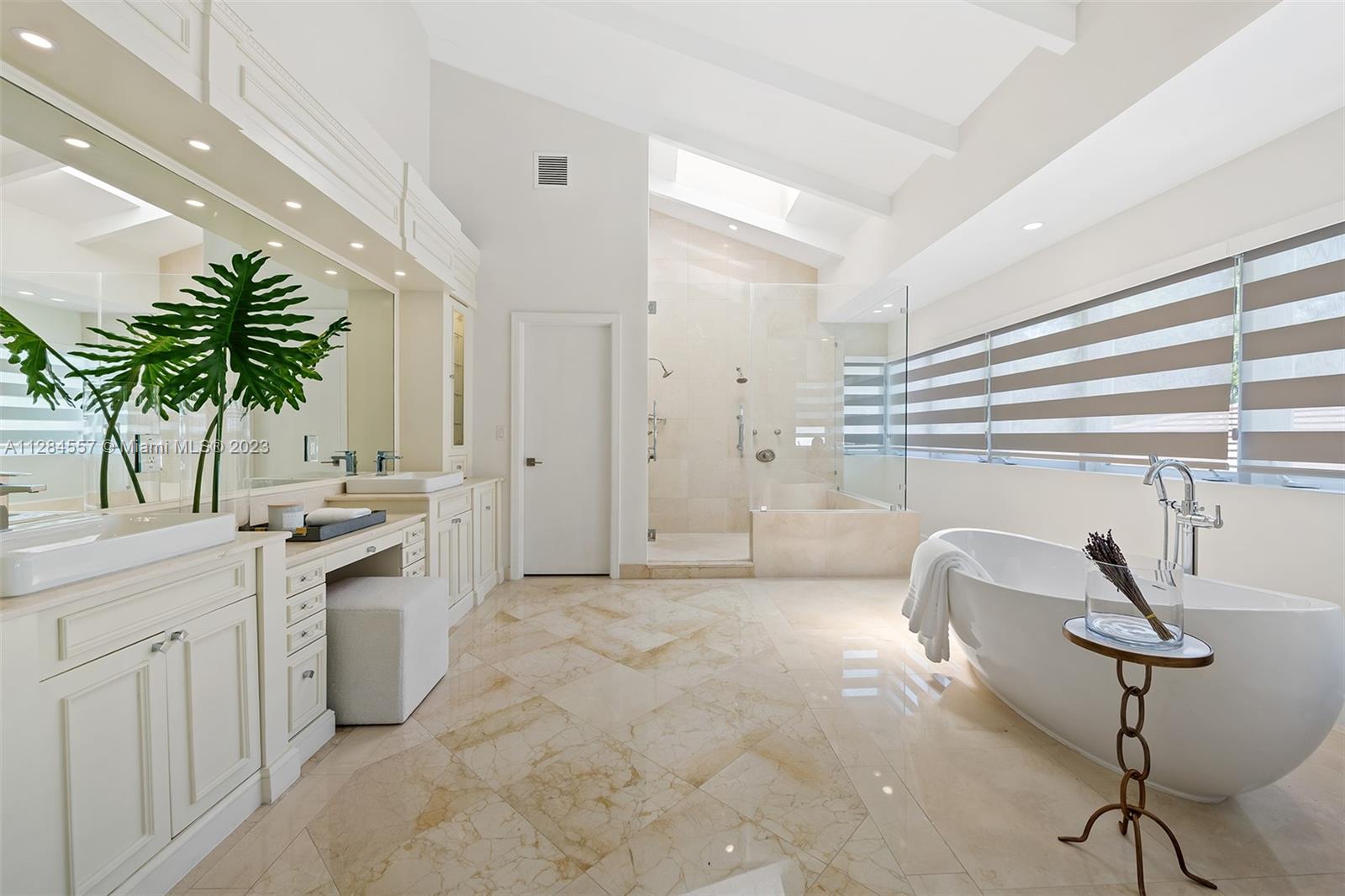 4845 Davis Road Miami, FL 33143 - Photo 19 of 34 a kitchen with a white cabinets and chandelier