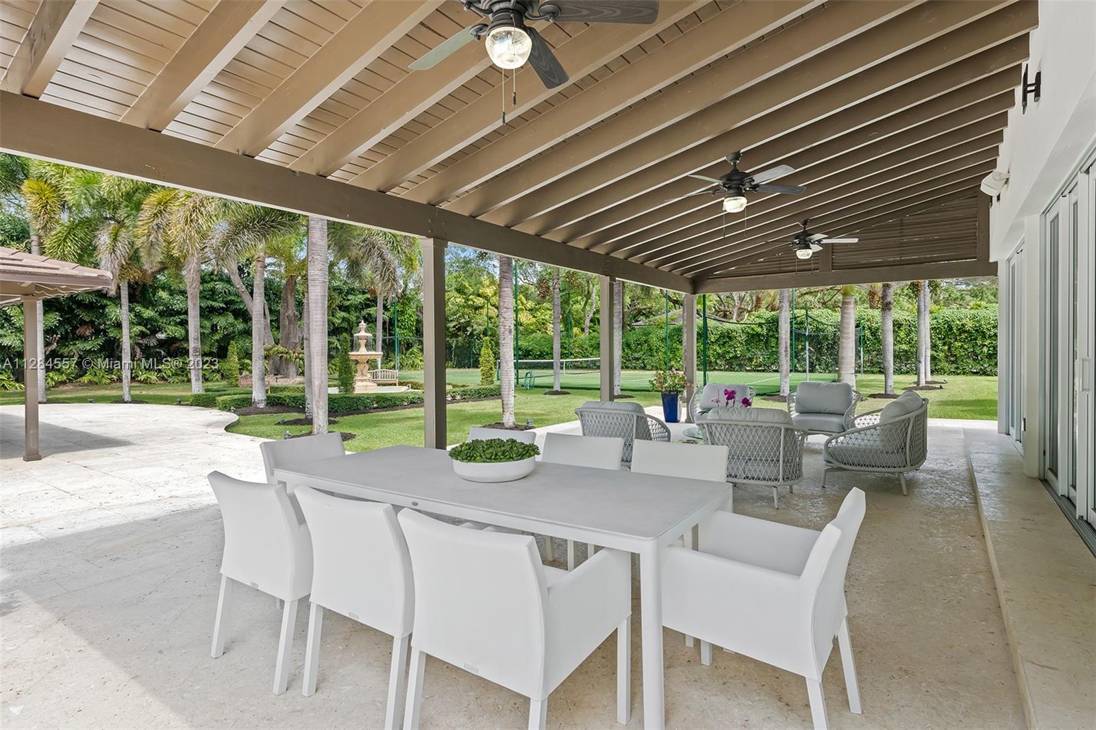 4845 Davis Road Miami, FL 33143 - Photo 29 of 34 a view of a patio with table and chairs and floor to ceiling window