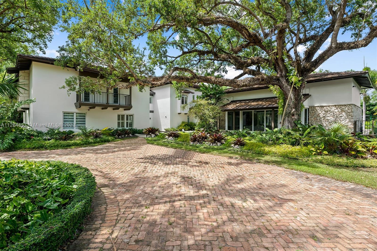 4845 Davis Road Miami, FL 33143 - Photo 4 of 34 a front view of a house with a yard and trees