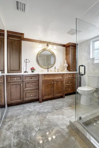 a spacious bathroom with a sink double vanity and a mirror