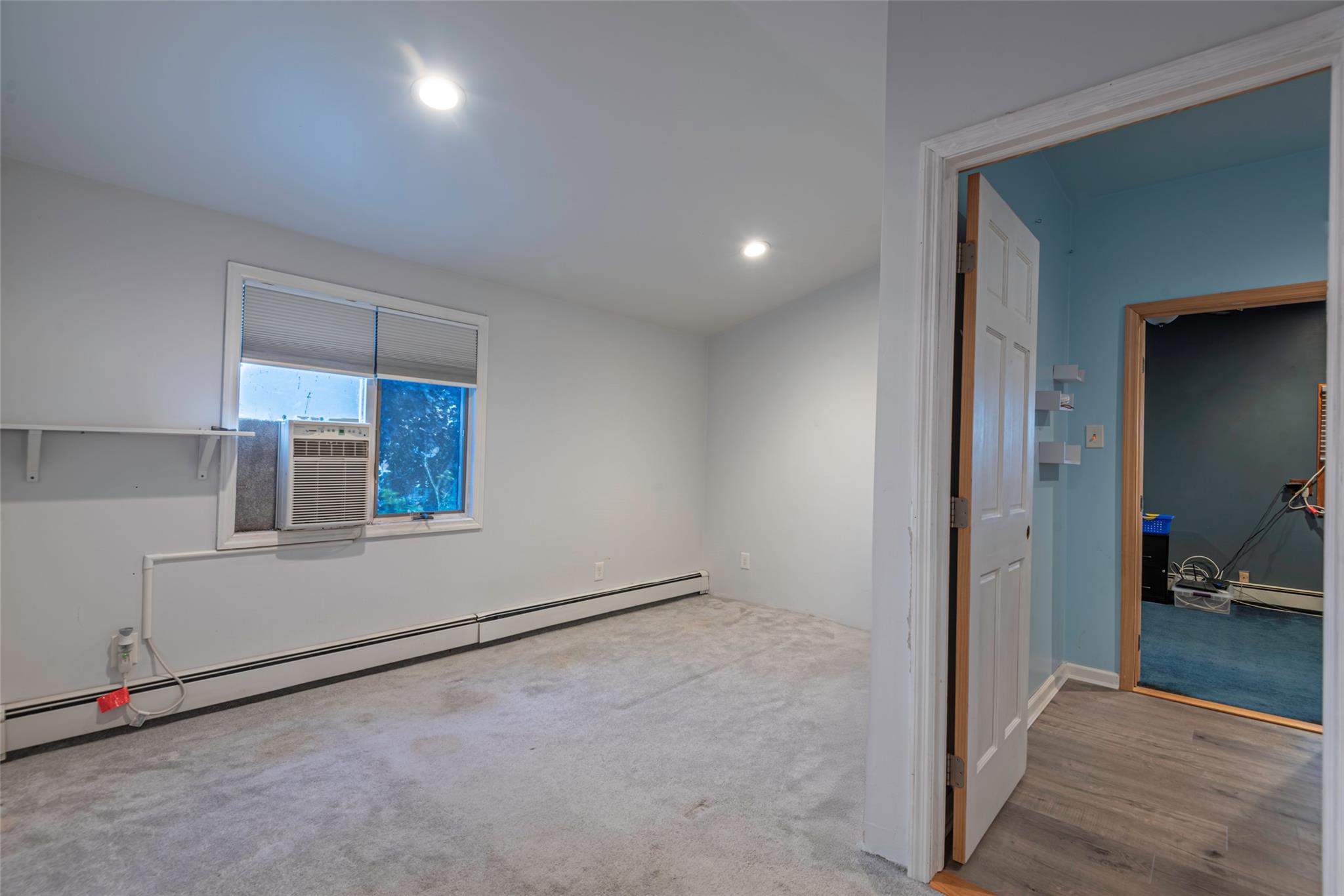 22 Lowland Road Levittown, NY 11756 - Photo 19 of 38 Empty room featuring a baseboard radiator, carpet floors, cooling unit, and recessed lighting
