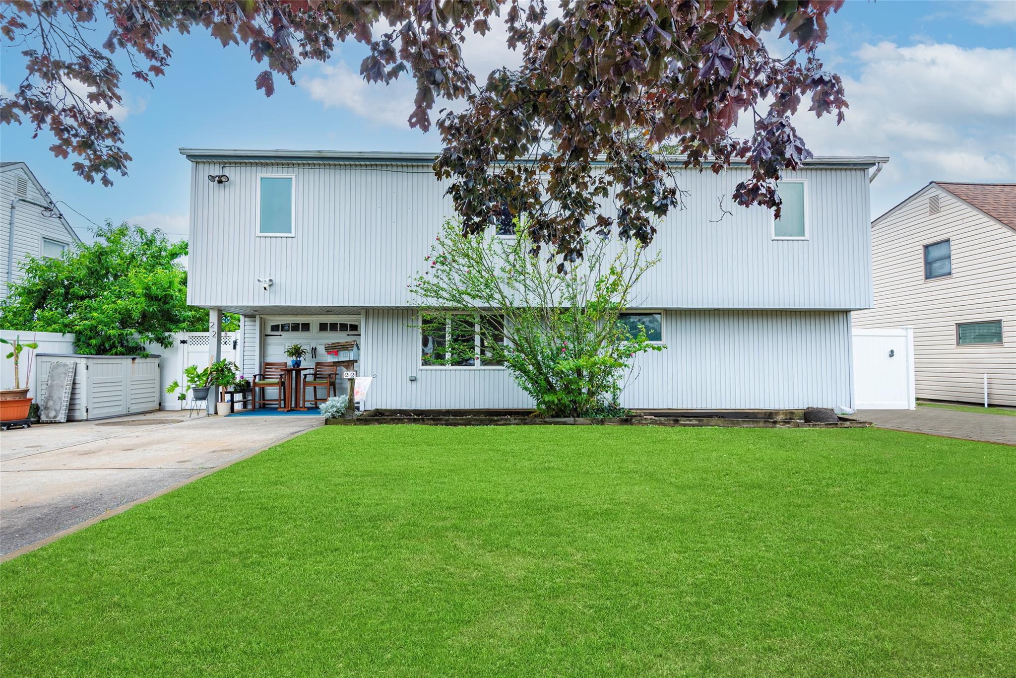 22 Lowland Road Levittown, NY 11756 - Photo 2 of 38 View of front facade with driveway and a garage